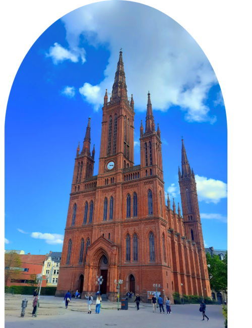 A neoclassical red-brick church standing tall in a city square