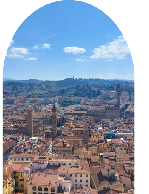 Skyline of Italy's Florence with tall towers in the distance and rustic tiled roofs underneath them